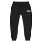 Embrace the Journey Joggers in Black — front view with embroidered left-thigh design