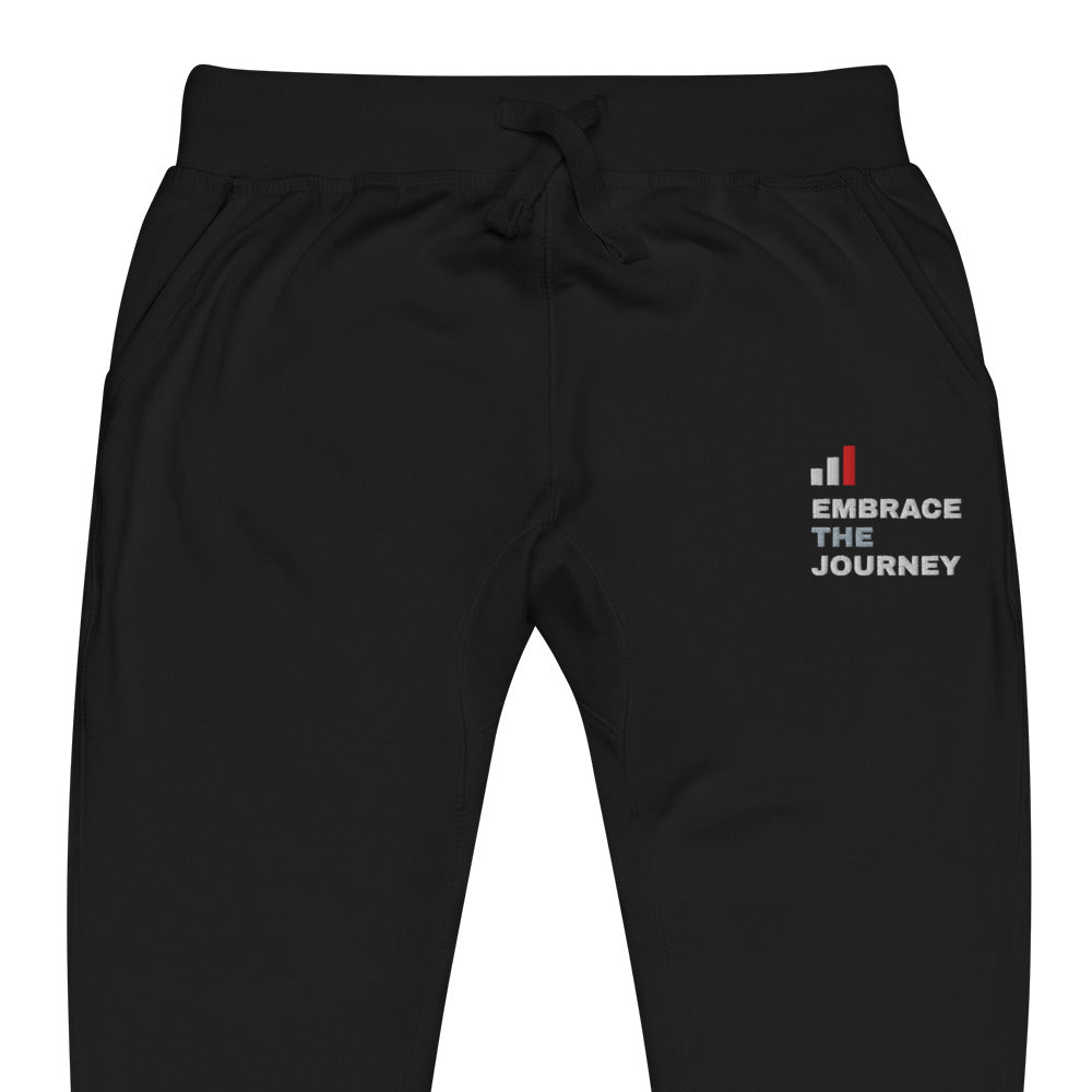 Embrace the Journey Clean Stack Joggers in Black — close-up of the embroidered Clean Stack logo at the left thigh