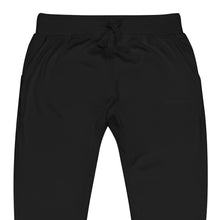 One Step at a Time Joggers in Black — close-up of the embroidered One Step at a Time logo at the left thigh
