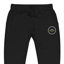 Summit Emblem Joggers in Black — close-up of the embroidered Summit emblem at the left thigh