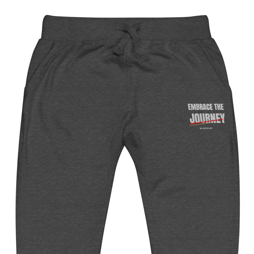 Embrace the Journey Joggers in Charcoal Heather — close-up of the embroidered Embrace the Journey design at the left thigh